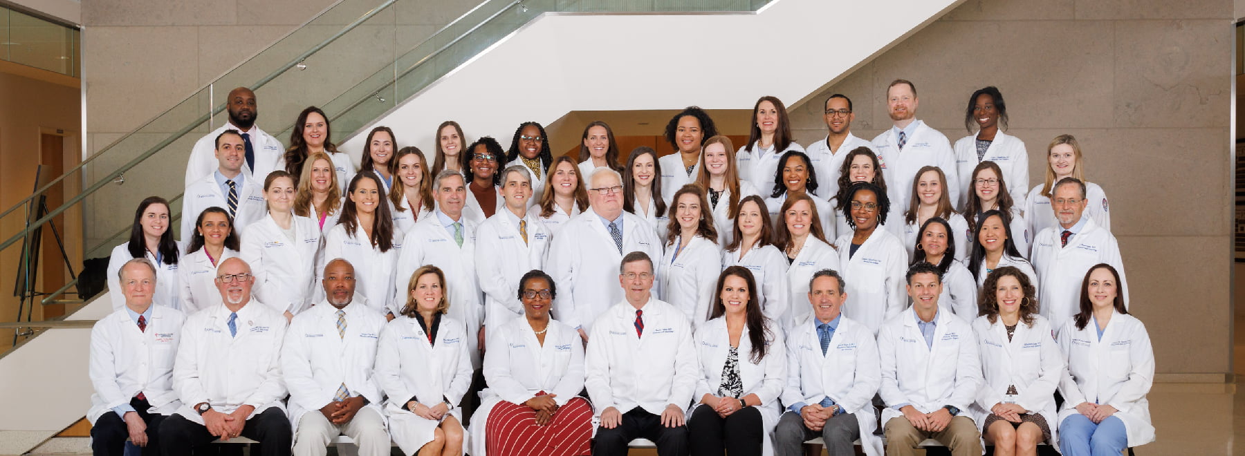 The Department of Obstetrics and Gynecology poses for a group photo in the lobby of the School of Medicine